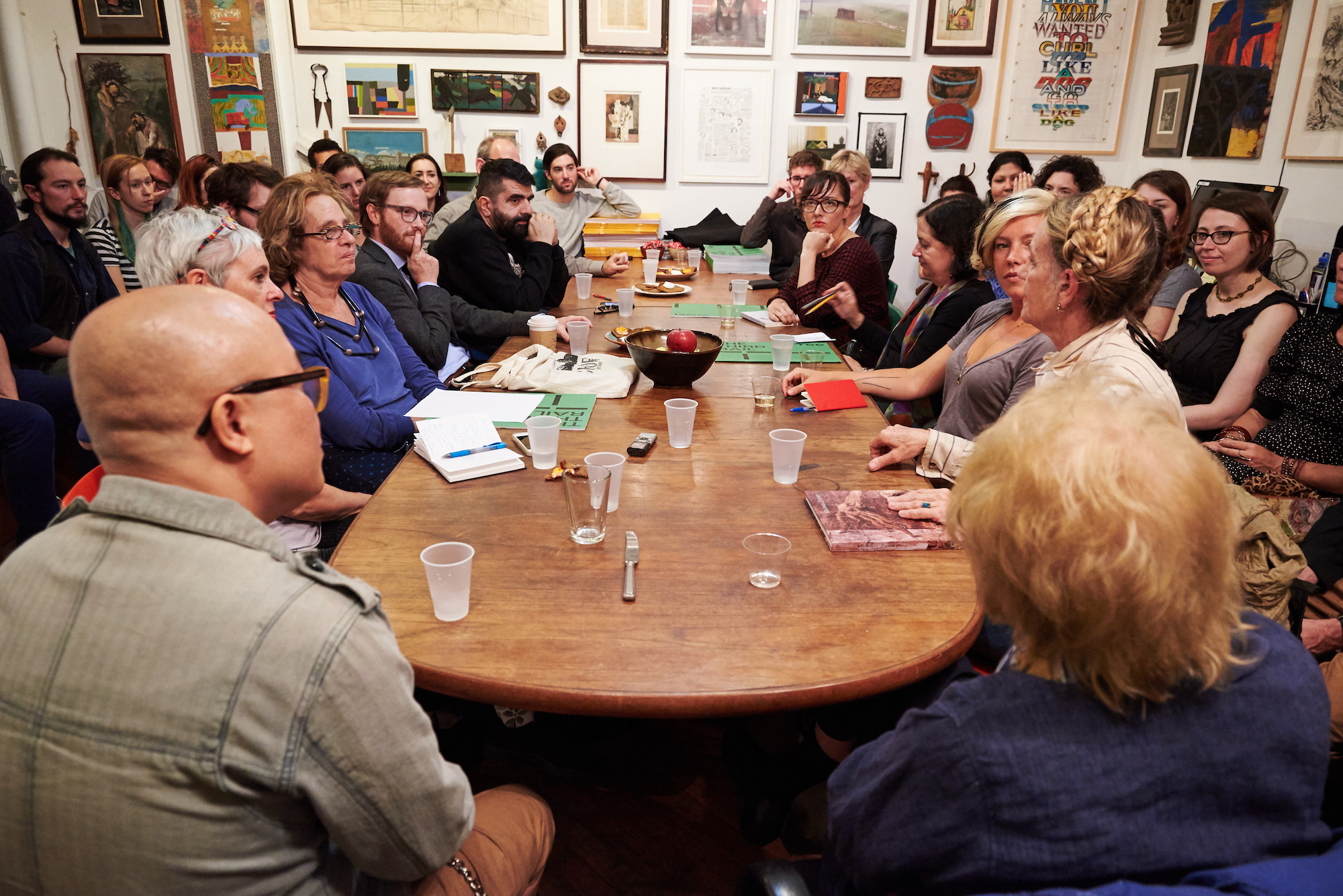 People have a discussion around a table.