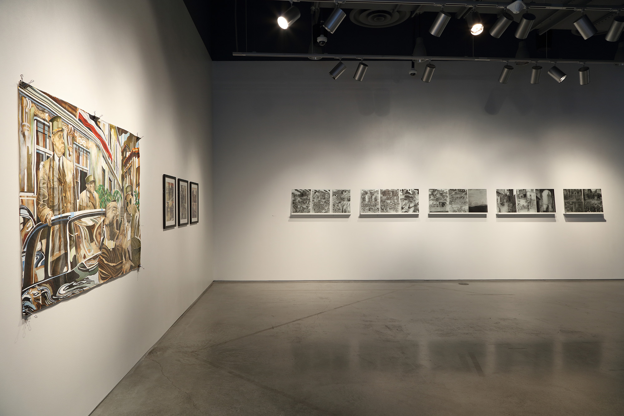 Installation view of four hanging pieces on left hand wall and five groups of three artworks on side by side shelves