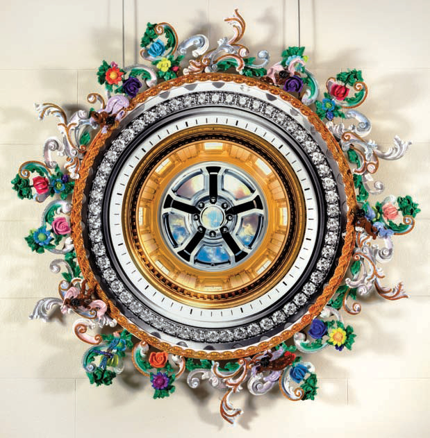 a round multicolor decorated object hangs, with rows of metal, jewels, and floral embellishments