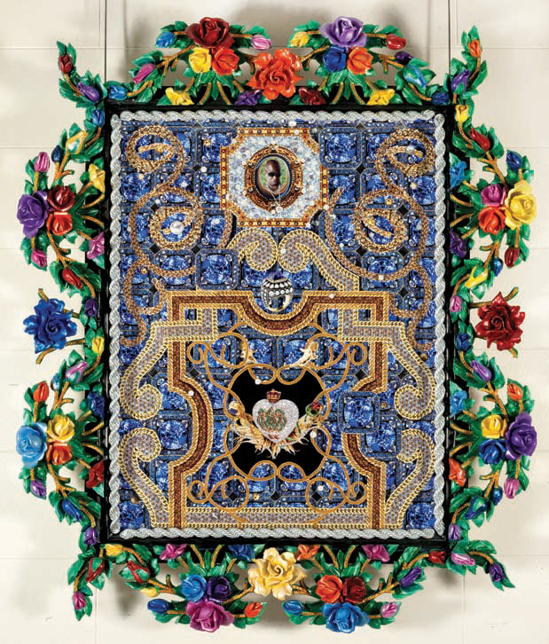 a rectangular ornate object covered in jeweled patterning and floral ornament hangs against a white wall
