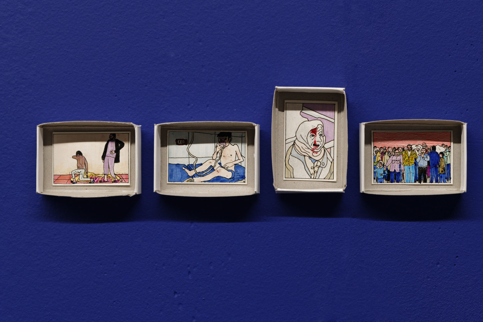four works hang on a deep blue wall; the works are outlined drawings framed by the lid to a shoebox