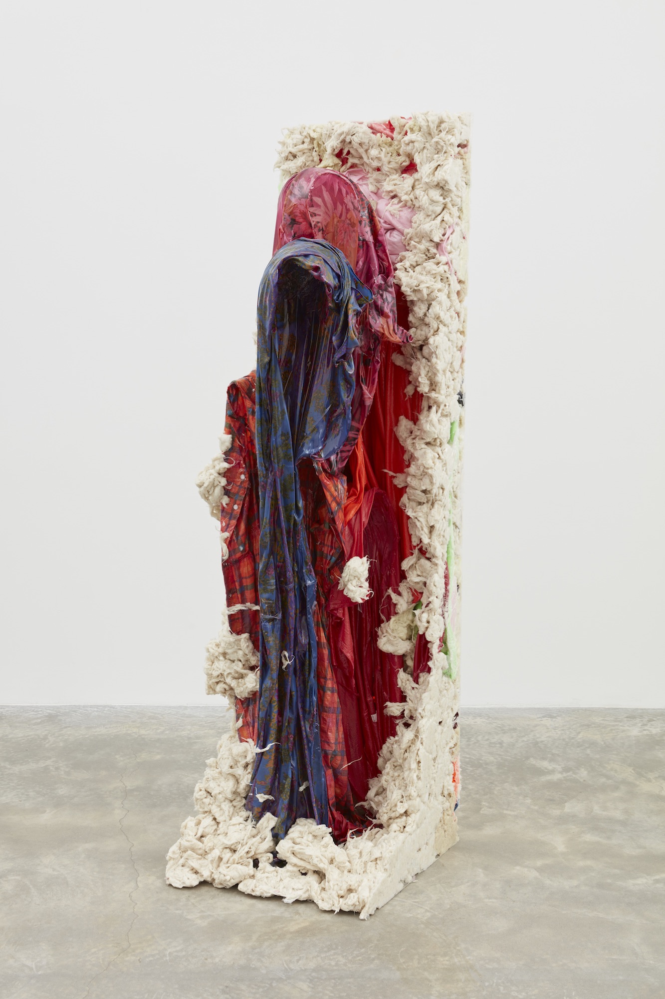 A polyurethane resin coated kaftan sculpture cast in a shape of a cloaked figure edged with raw cotton