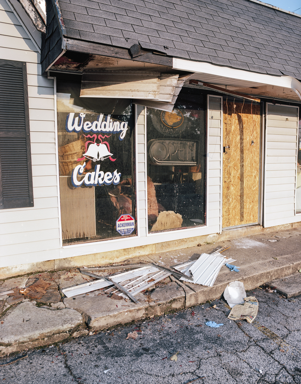 An abandoned wedding cake shop, with debris in front