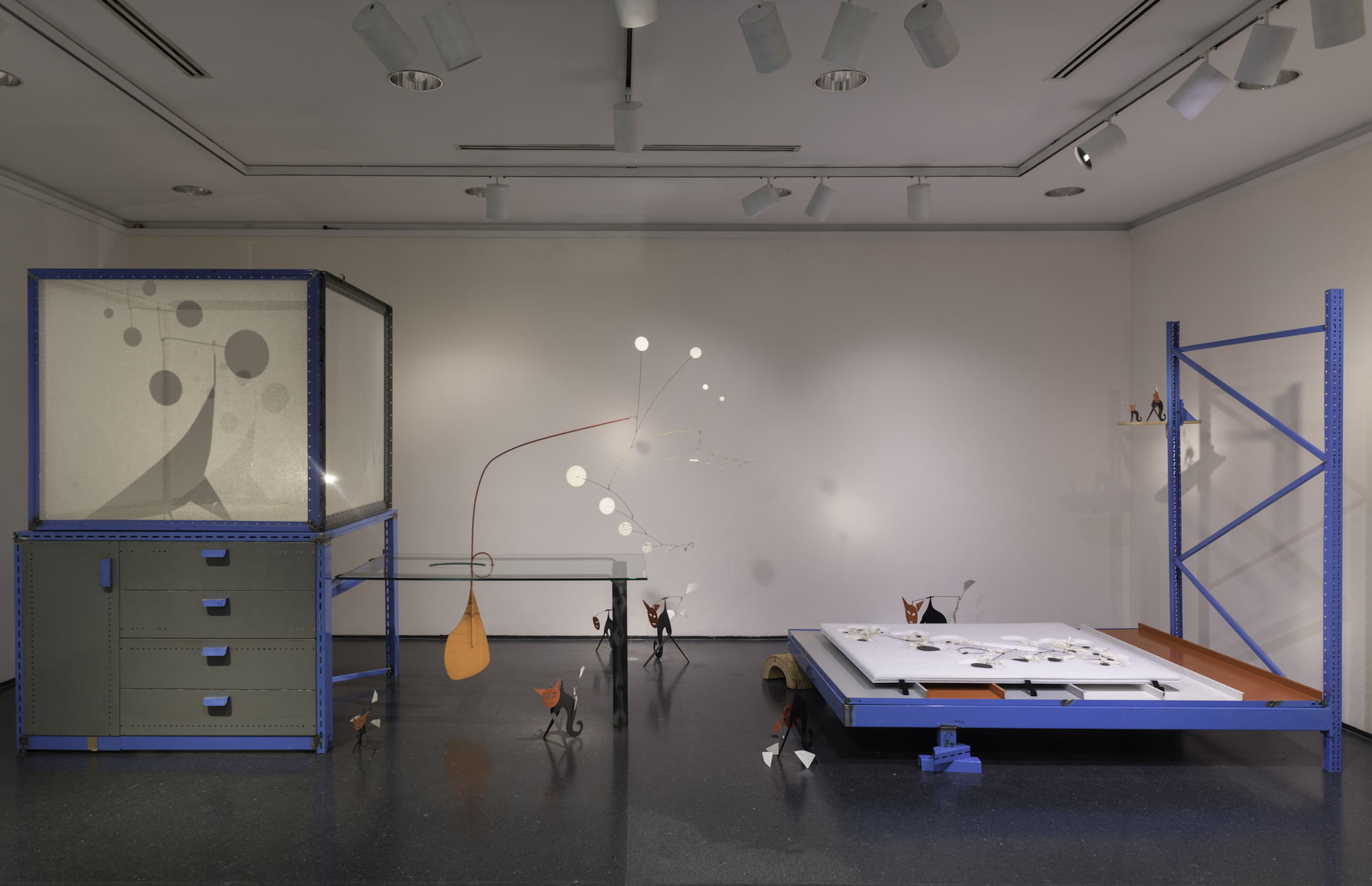 various large installation objects with blue paint in a white room