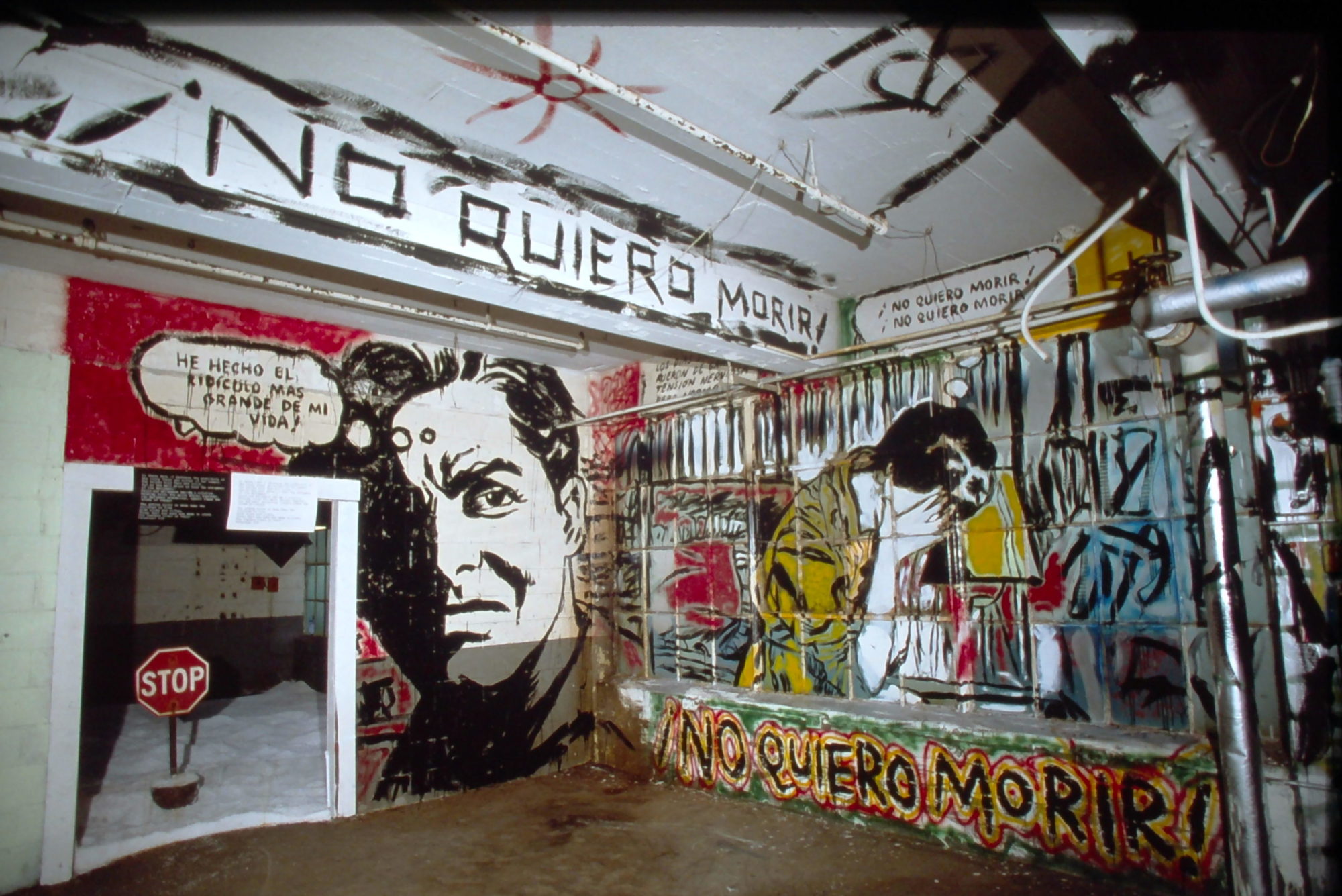 An image of an art installation with colorfully painted individuals and the phrase 