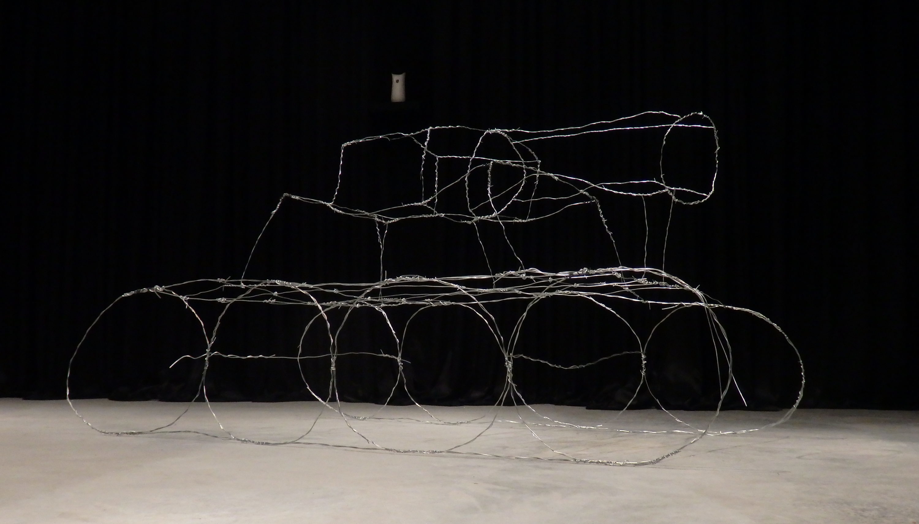 framework of a war tank made out of wire that is wrapped around itself