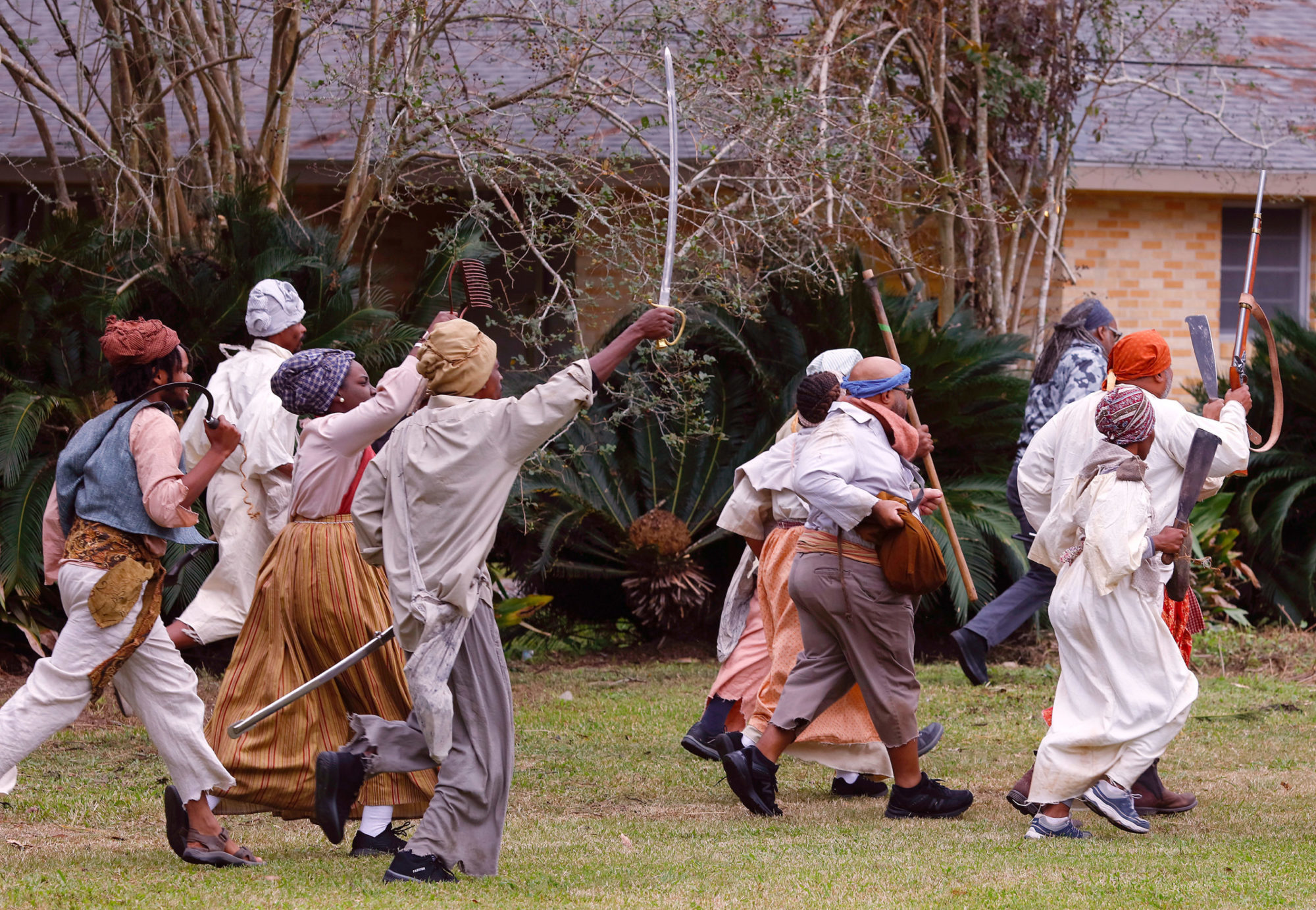 Documentation of the Slave Rebellion Reenactment, a community engaged performance initiated by Dread Scott in the outskirts of New Orleans