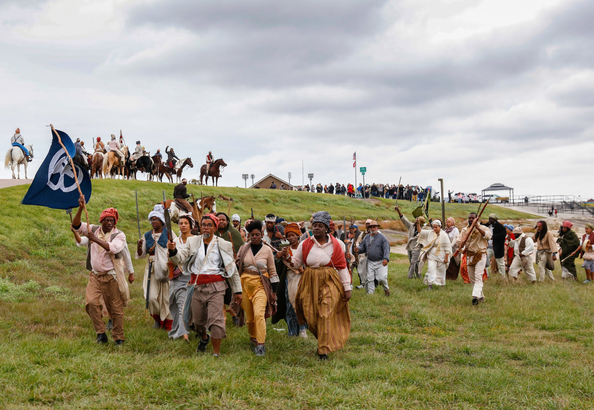 Documentation of the Slave Rebellion Reenactment, a community engaged performance initiated by Dread Scott in the outskirts of New Orleans