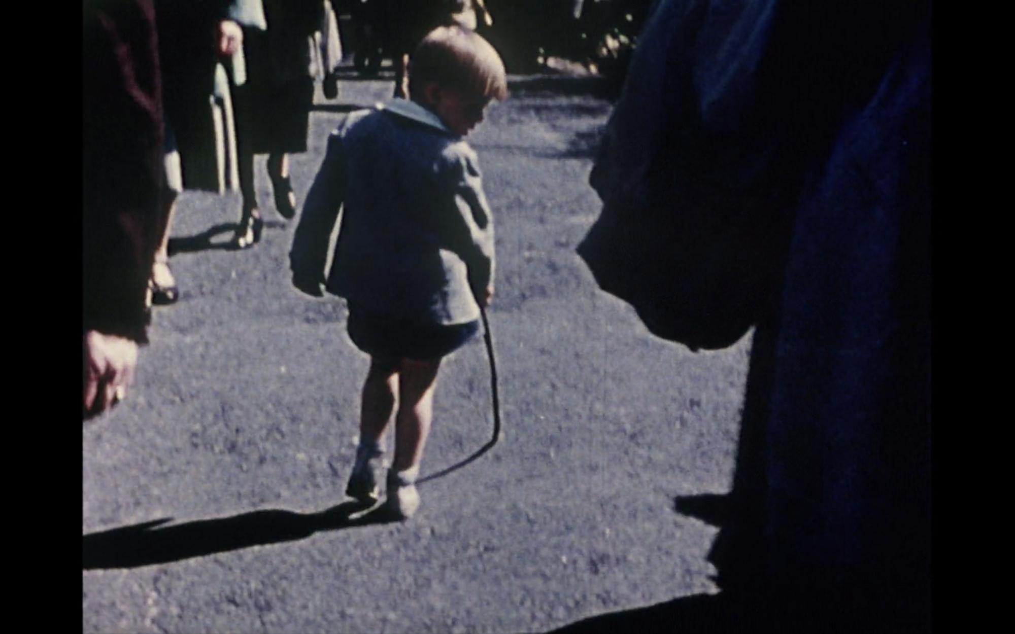 Screenshot from film Lost,Lost,Lost displaying a young boy looking backwards