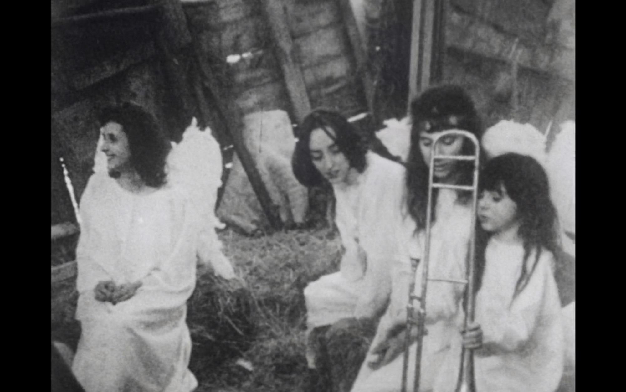 Screenshot from film Lost,Lost,Lost displaying 3 women dressed in white sitting