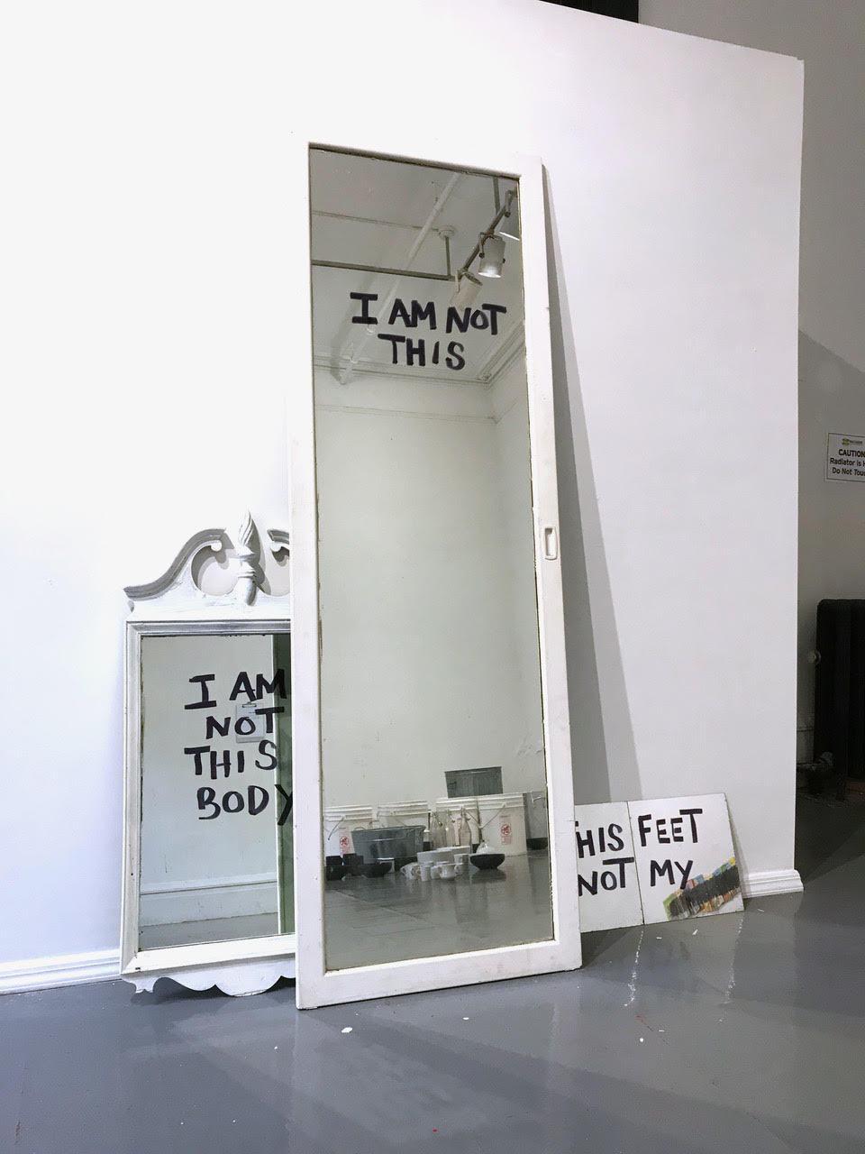 three different sized mirrors each display a different message
