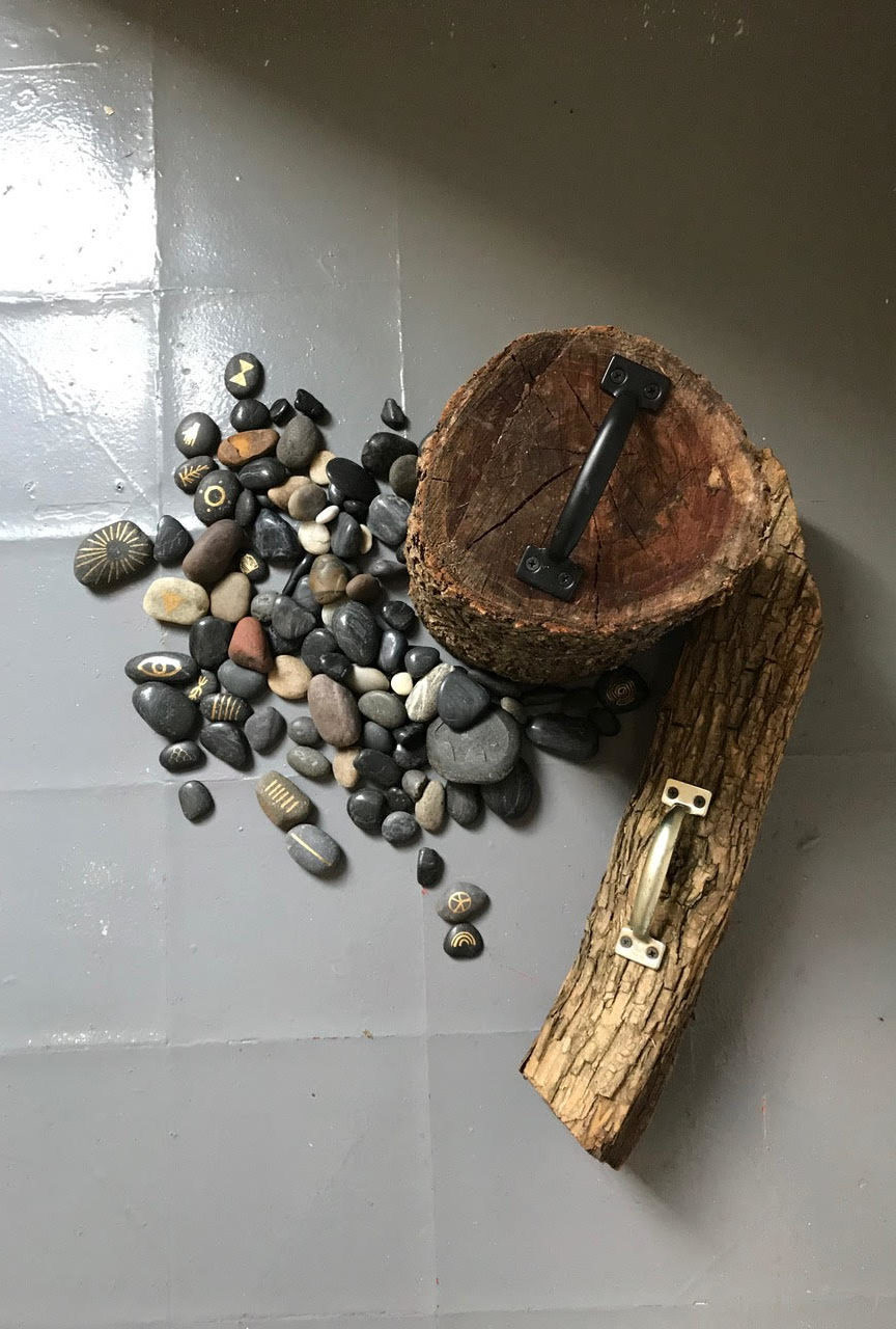 logs with handles attached and small rocks to one side