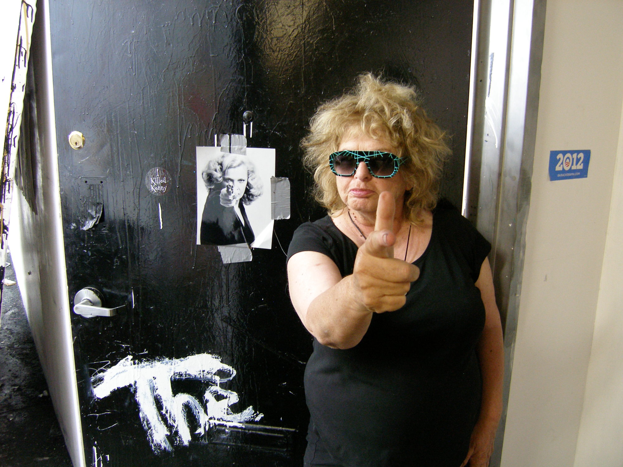 Photo of older white woman with blond hair pointing finger gun at camera next to a photo of a younger white woman doing the same.