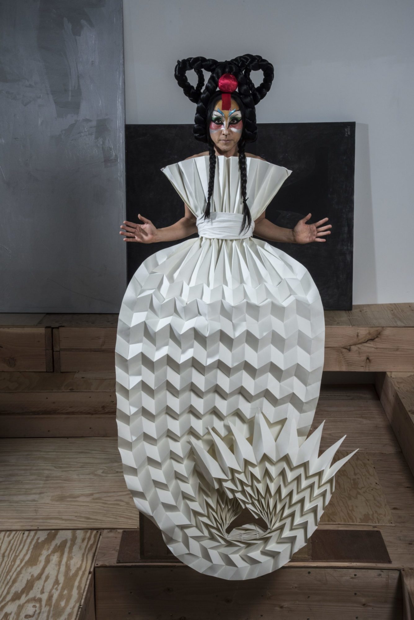 person wears paper dress shaped like fish tail