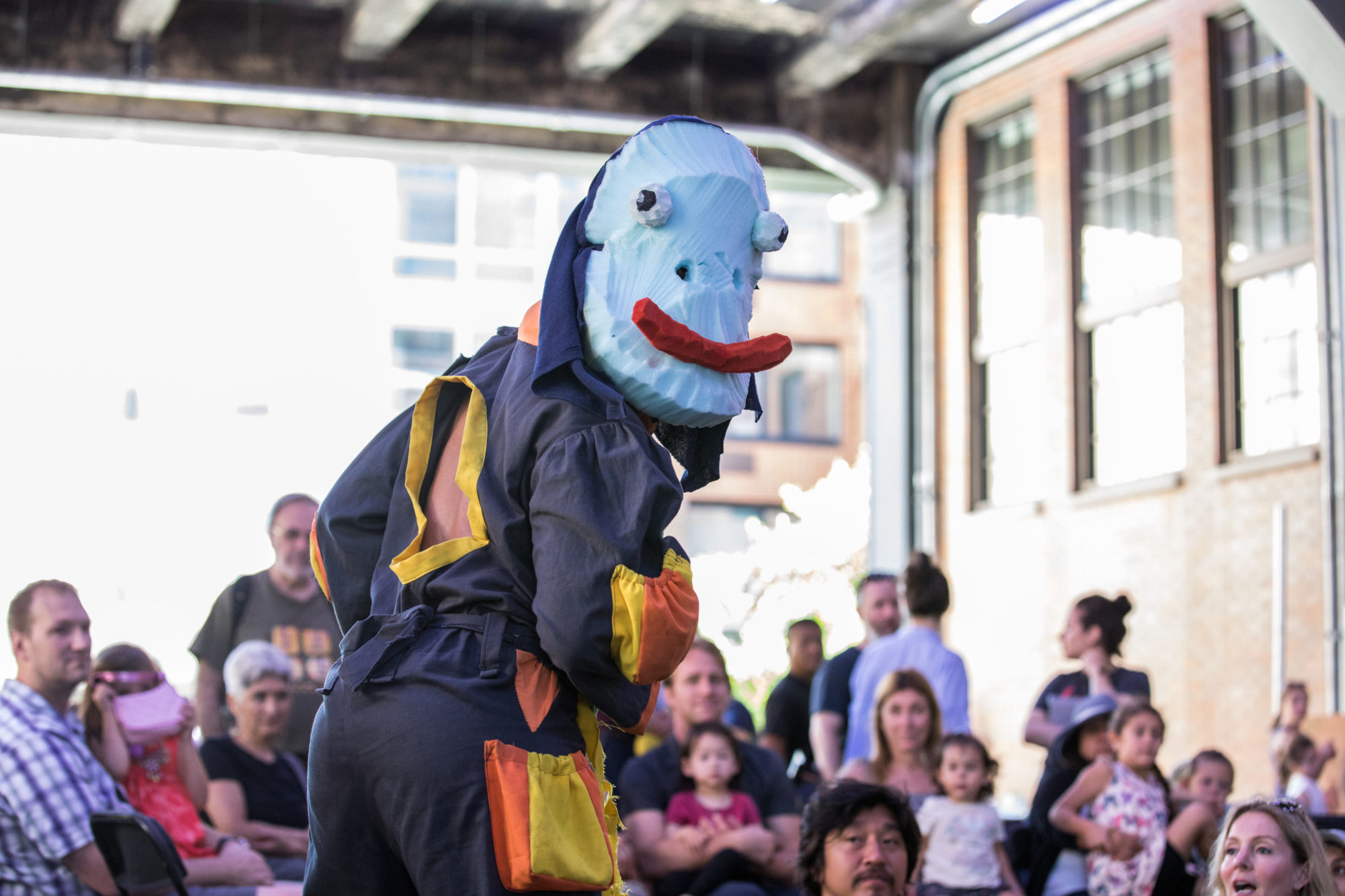 person in a blue mask stands out among other people