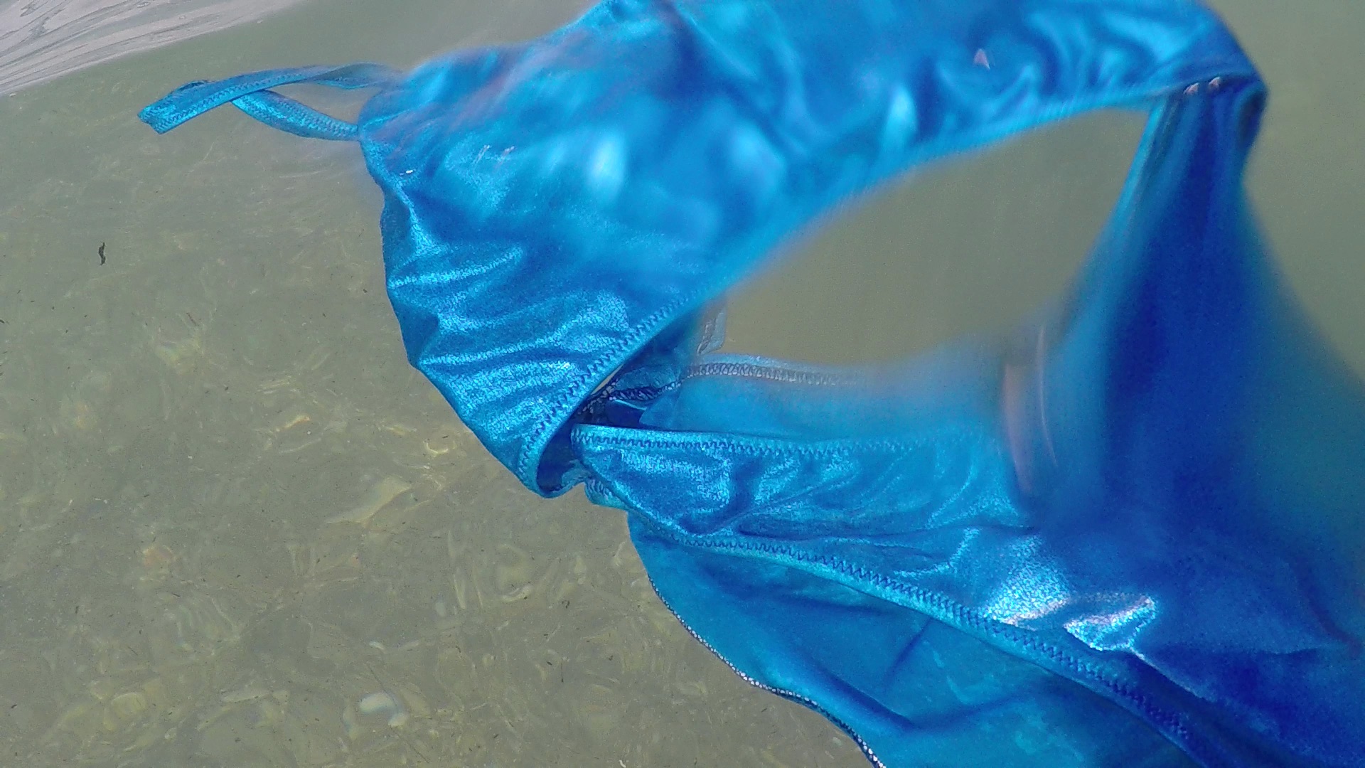 A blue swimsuit floating in water