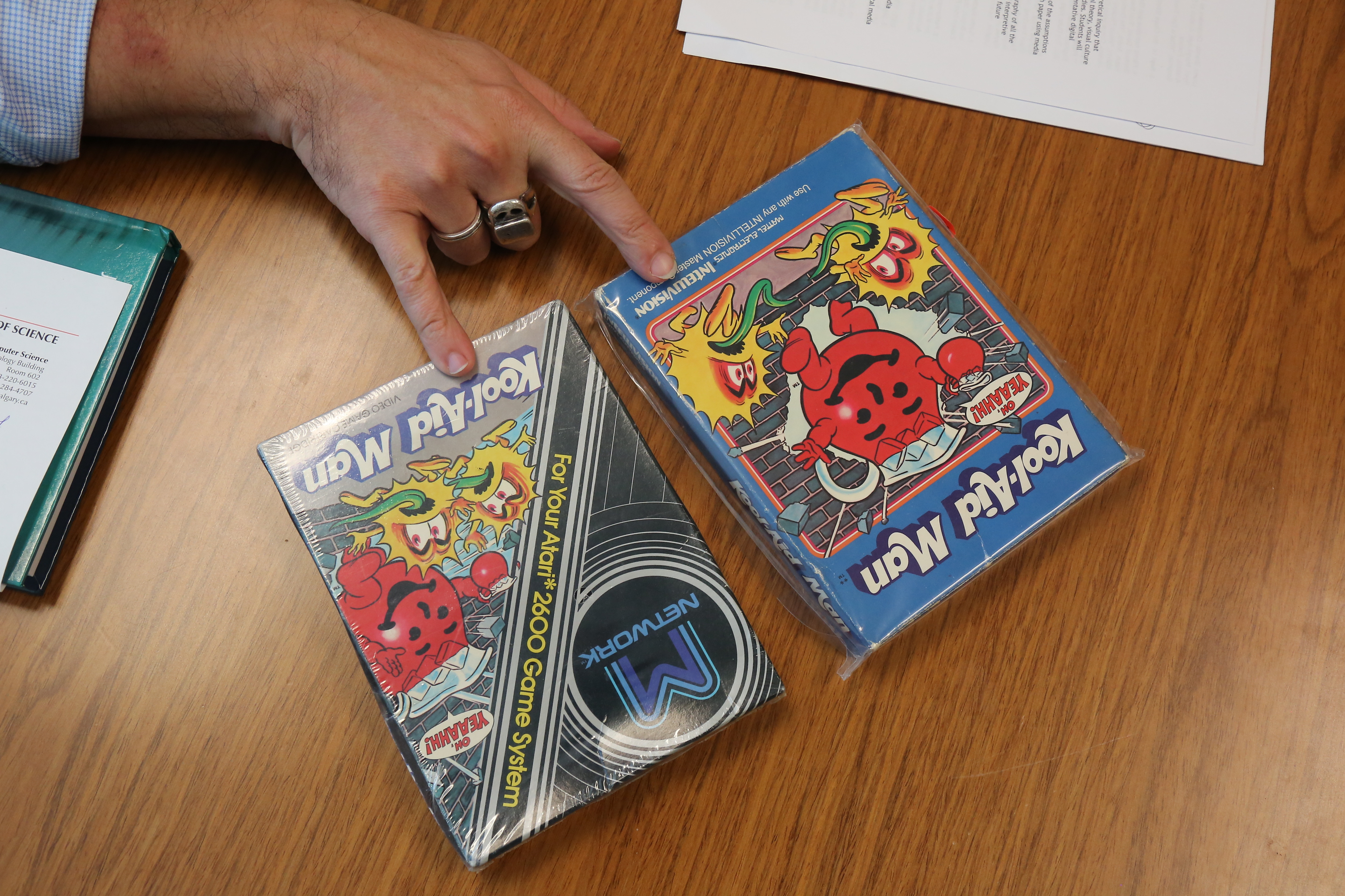 A closeup of Ian Bogost's fingers touching two copies of 