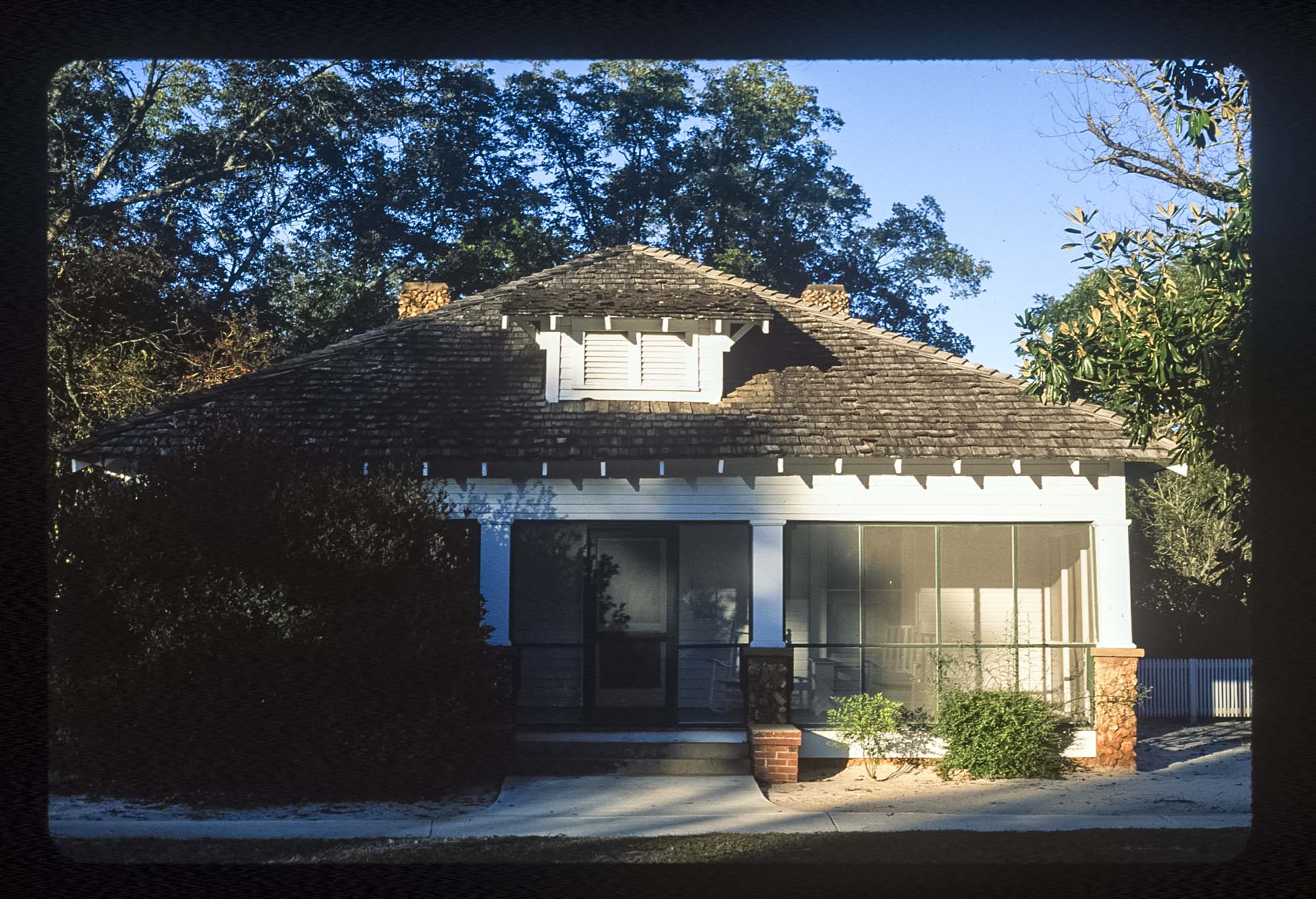 A white house with a screened porch