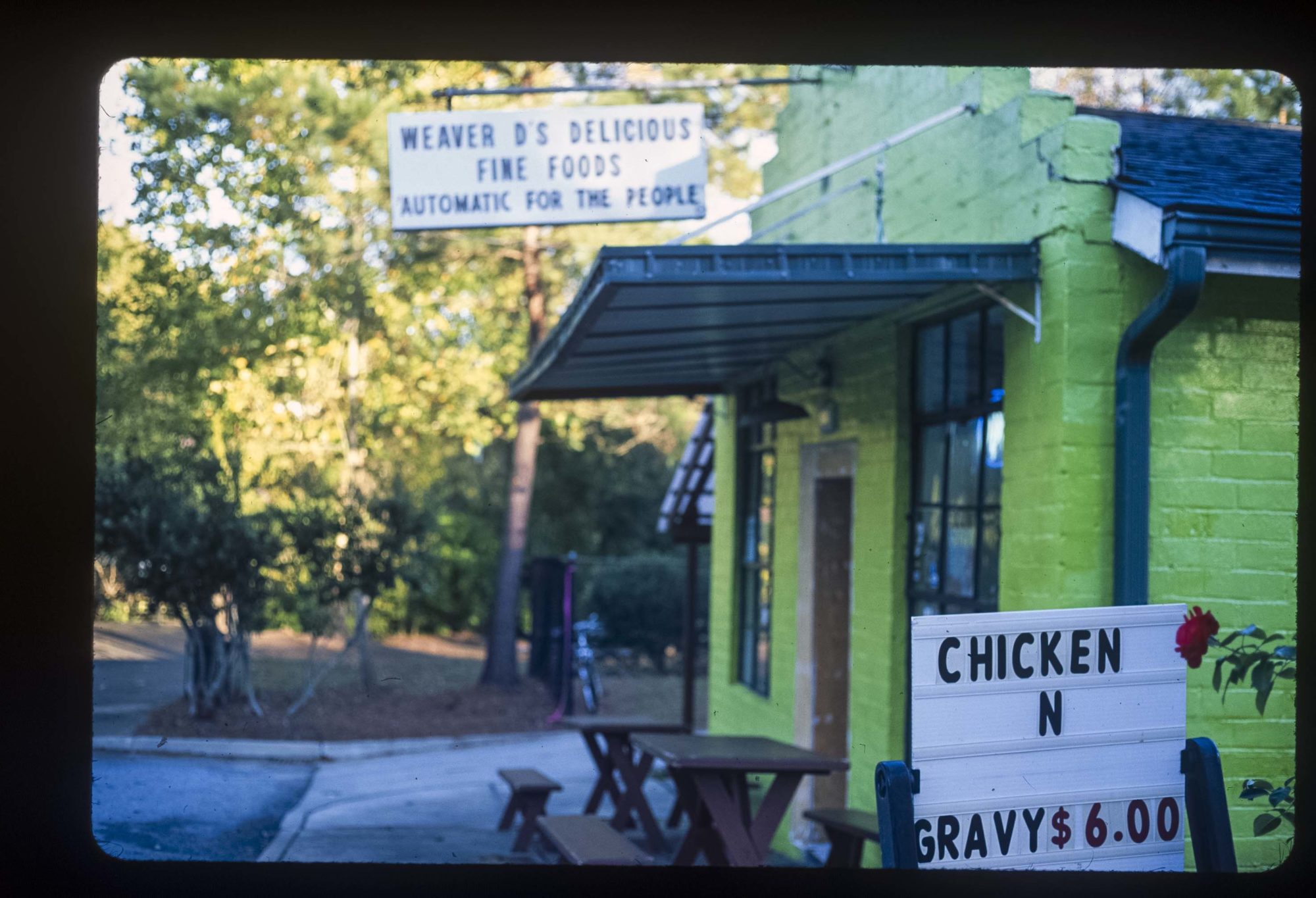 A green storefront of a small restaurant