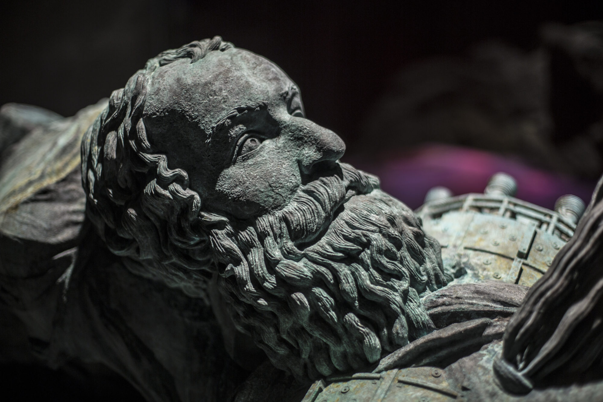 A closeup installation image of a tarnished bust of a man.