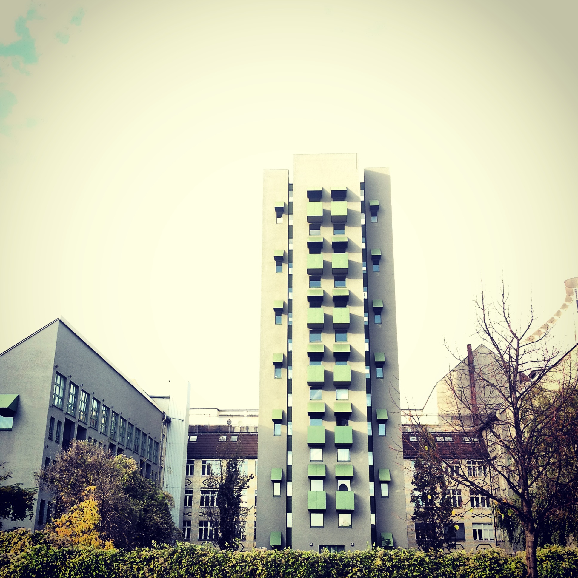 An architectual image of a highrise with green balconies