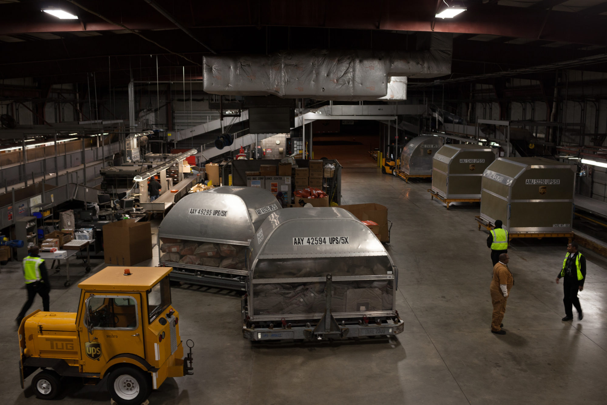 Two large metallic objects inside of a warehouse.