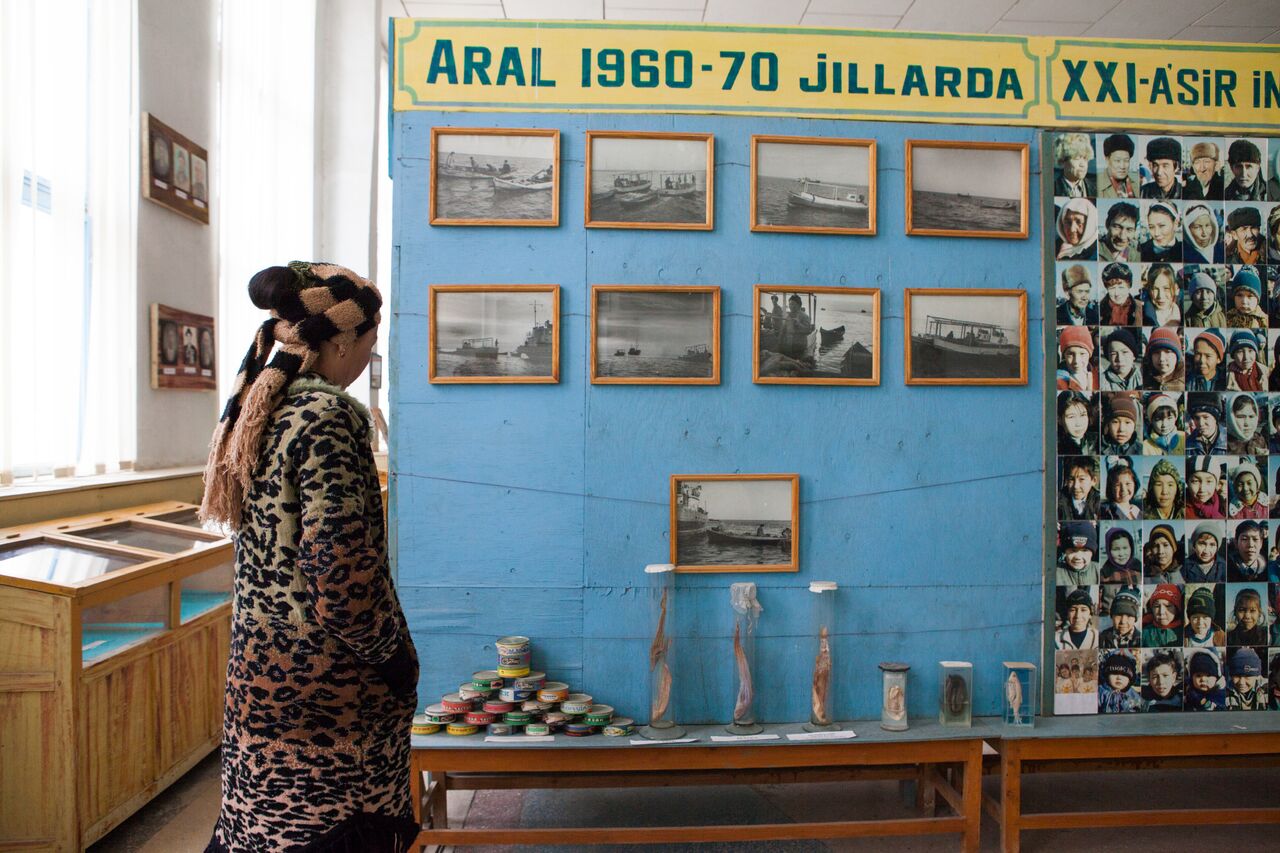 A woman wearing animal print clothing observing a memorial