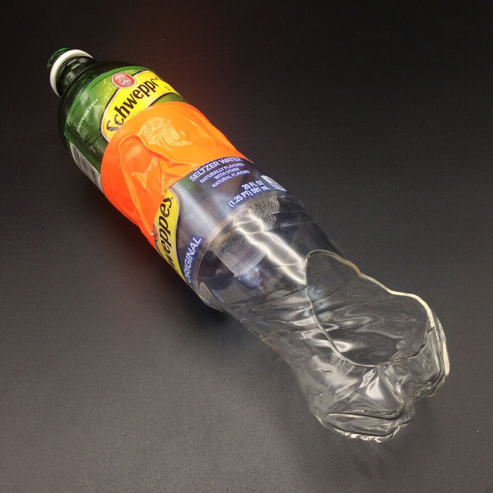 A urinary device shaped like a pipe that is constructed of two Schwepps soda bottles.