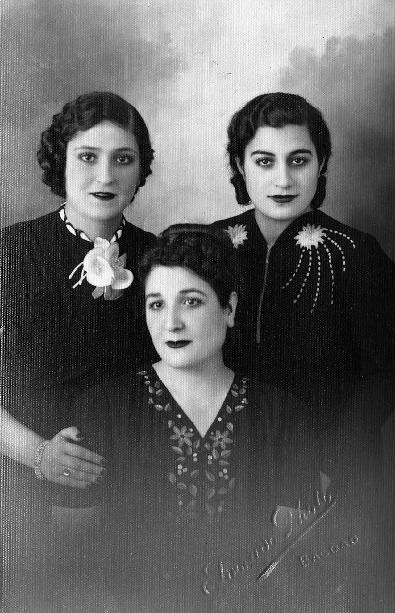 A black and white image of three women dressed in all black.