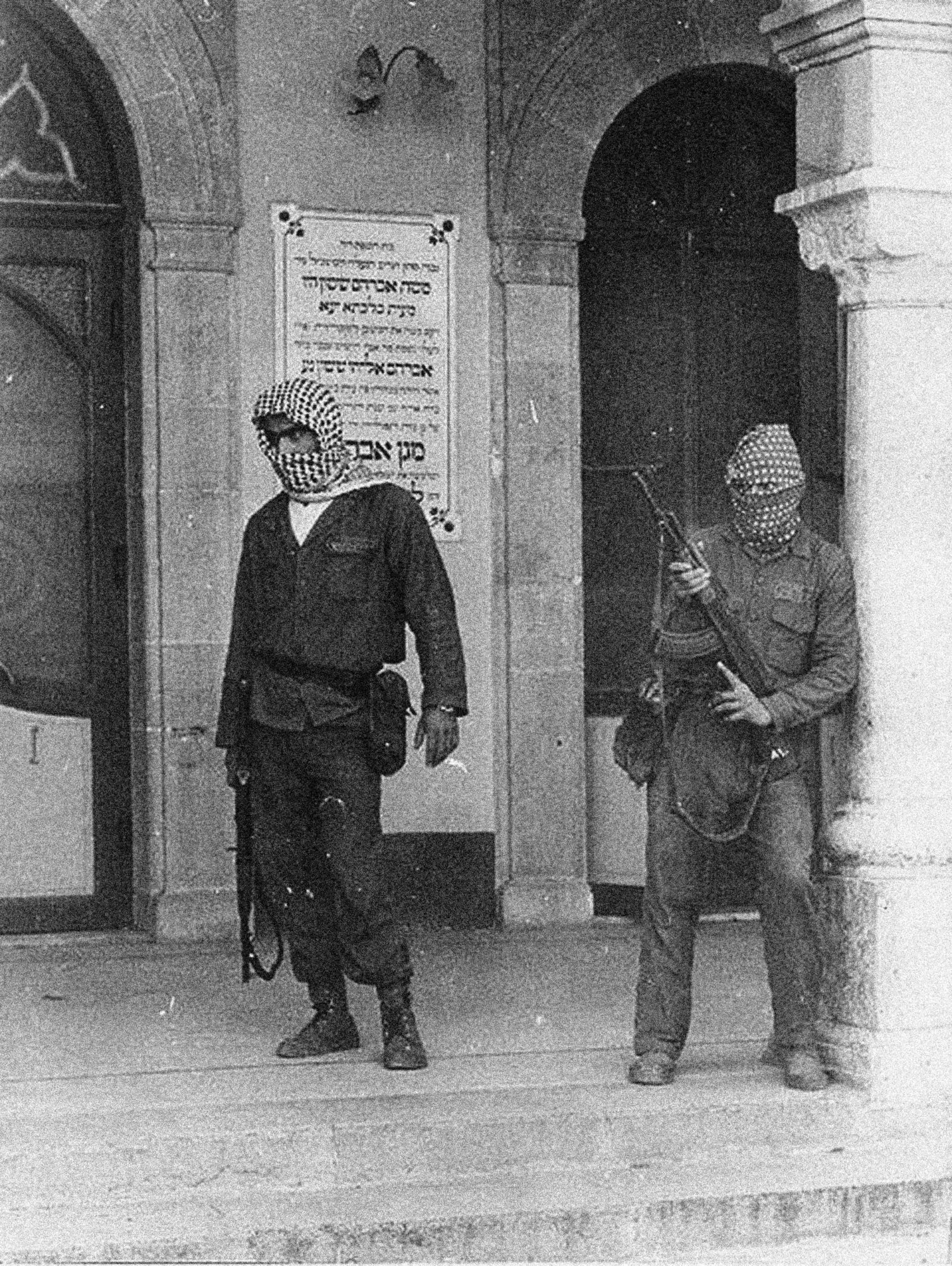 A black and white image of two armed men.