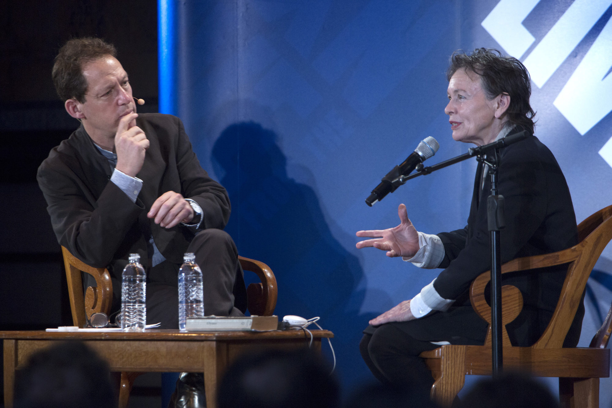 Paul Holdengråber sitting on stage as he interviews a woman