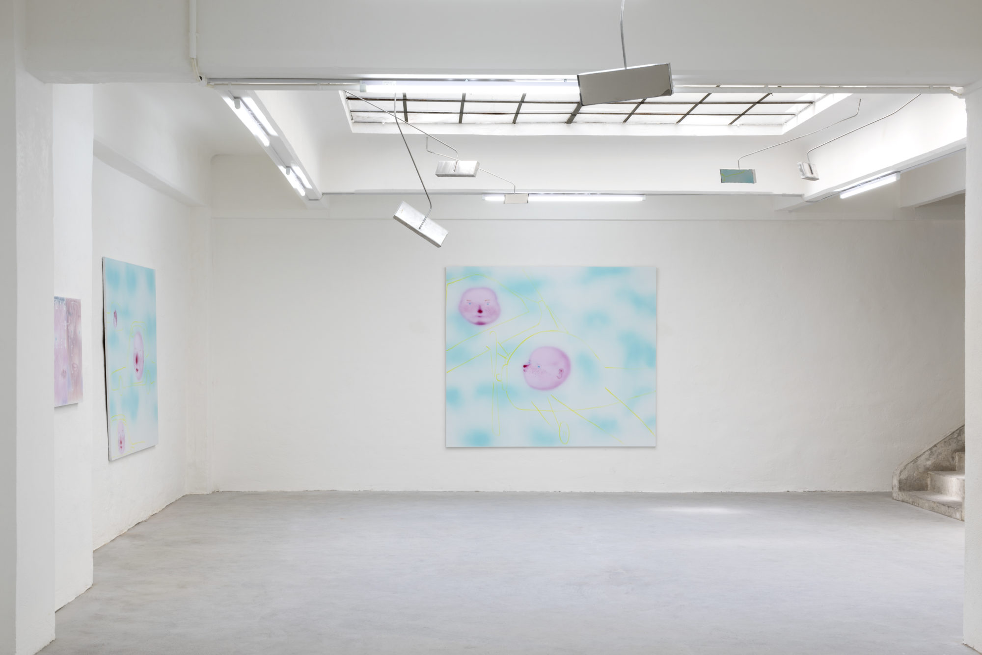 A blue and pink artwork hangs in a white gallery space