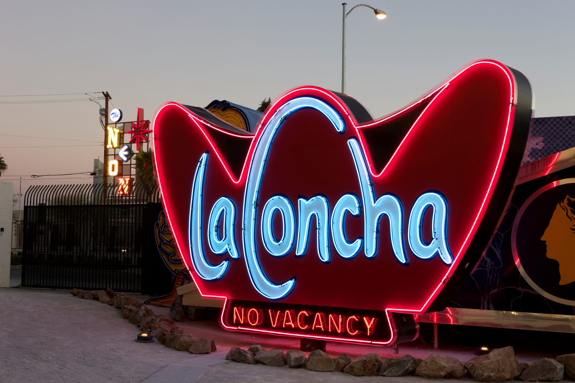 red lit sign with blue lettering