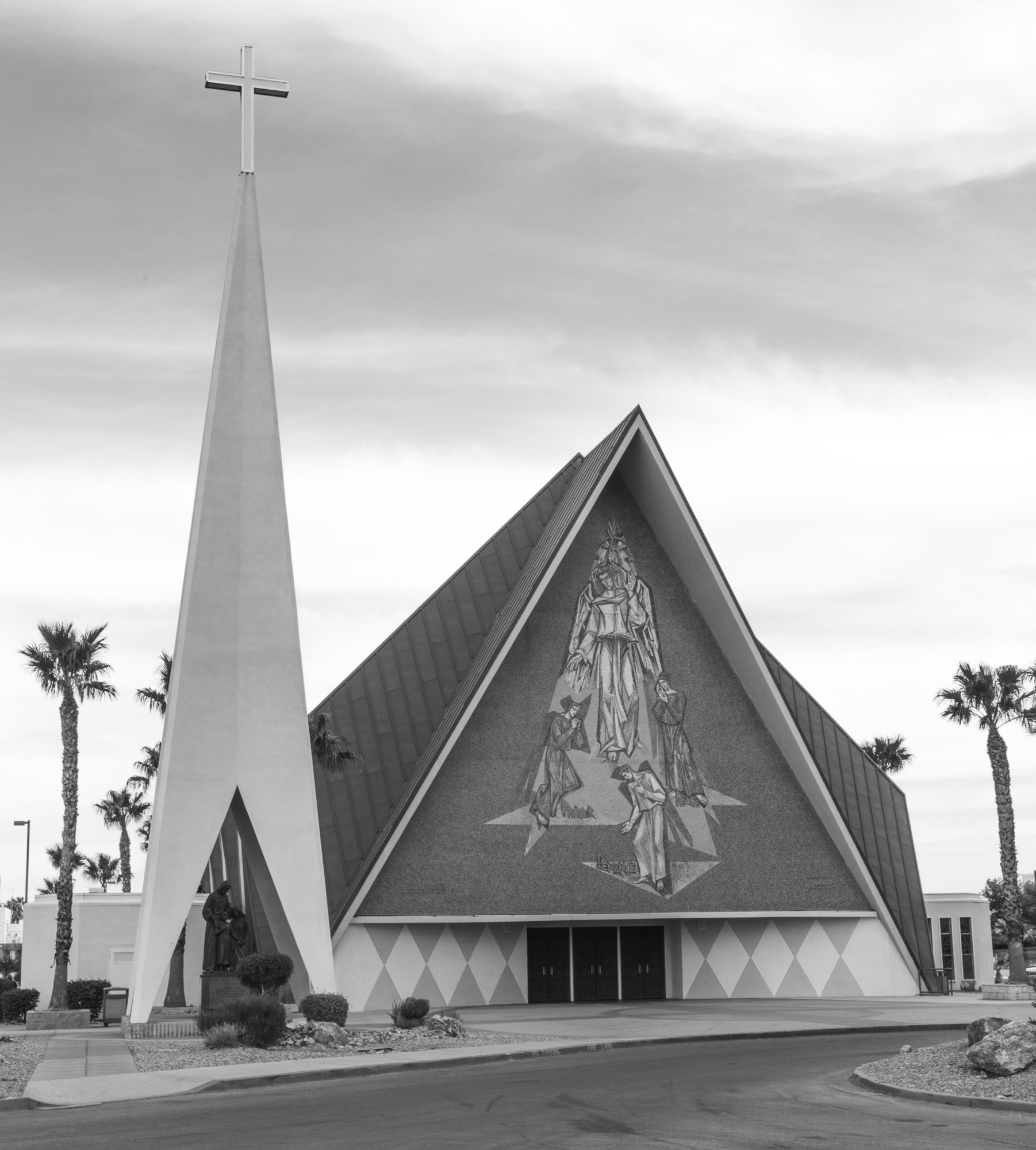 black and white photograph of the façade of Guardian Angel Cathedral, flanked by palm trees