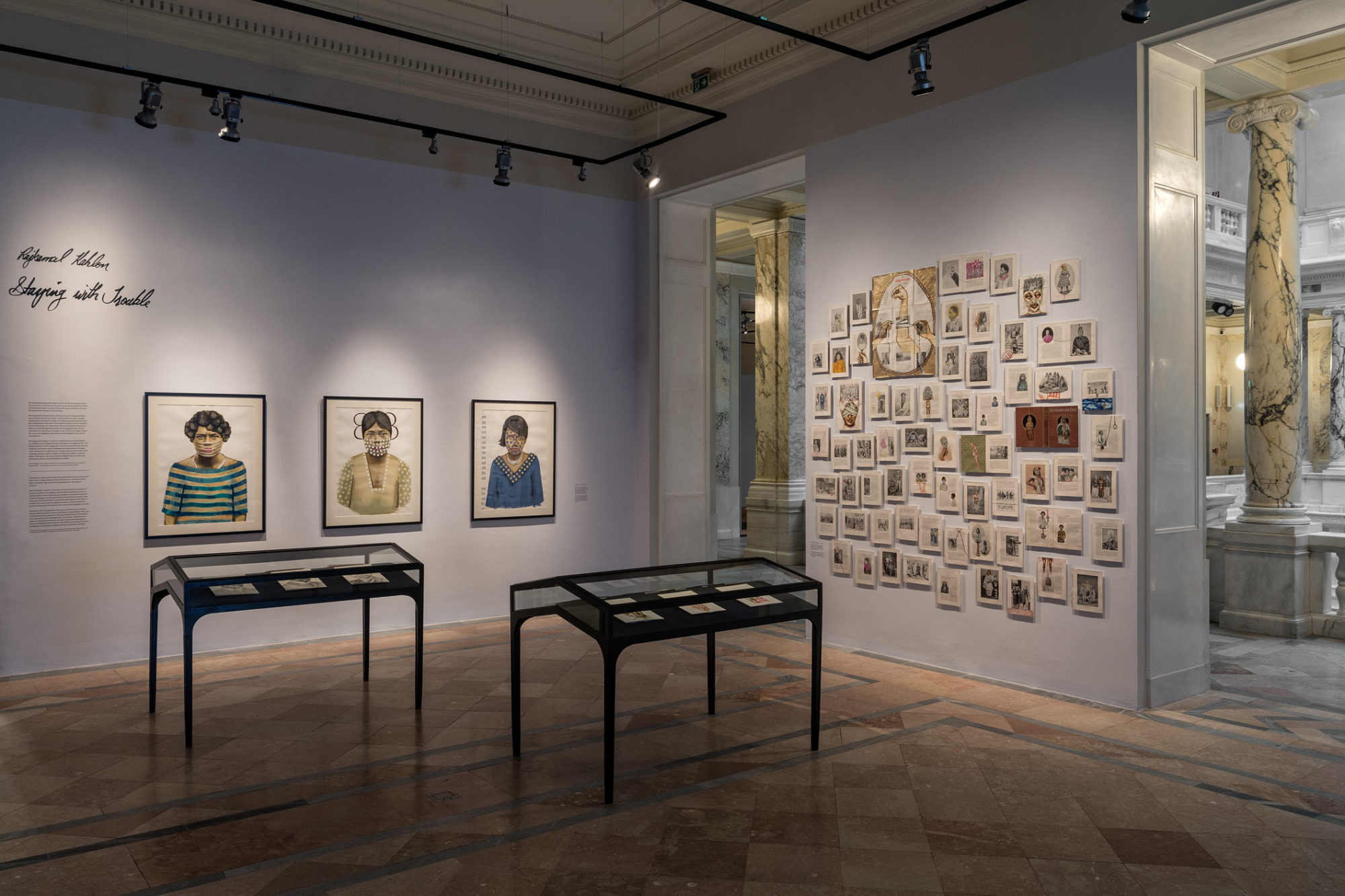 An installation view with many framed artworks on the walls