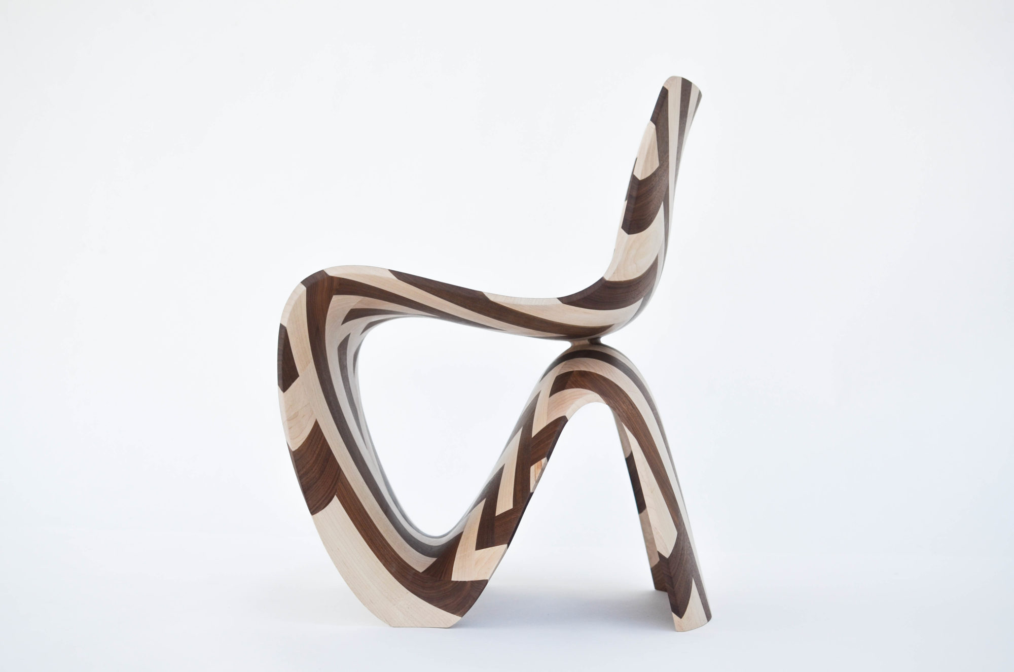 the side of a dark brown and white striped wooden chair