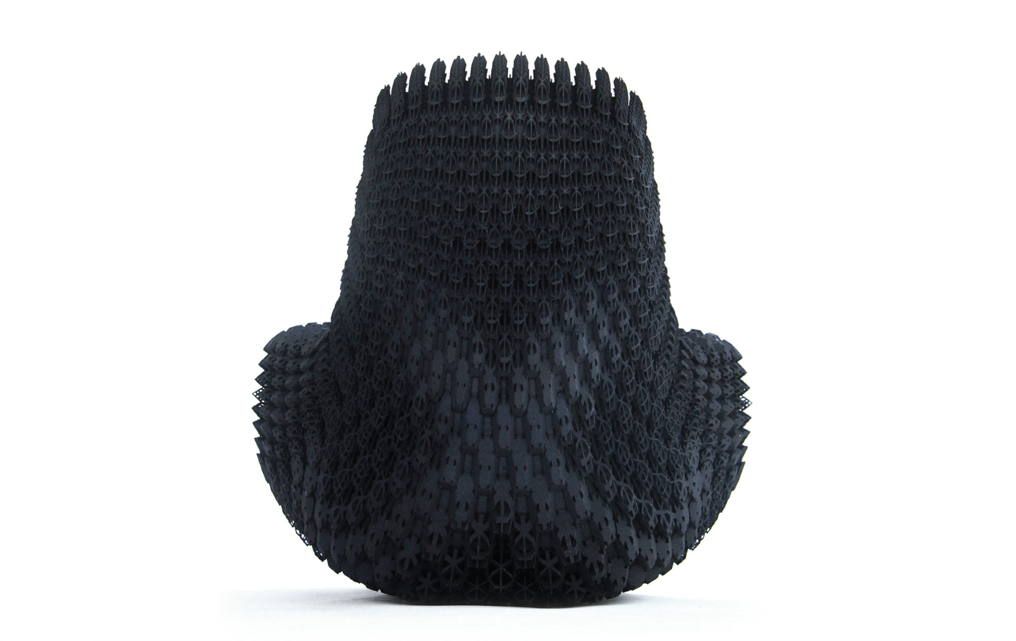 the back of a highly-textured, legless black chair