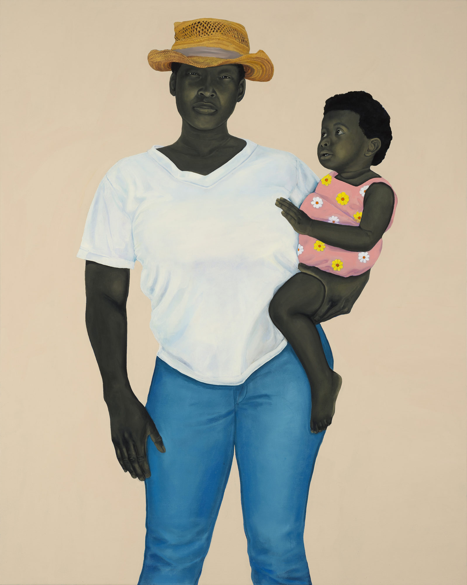 A woman in a hat holds a baby girl