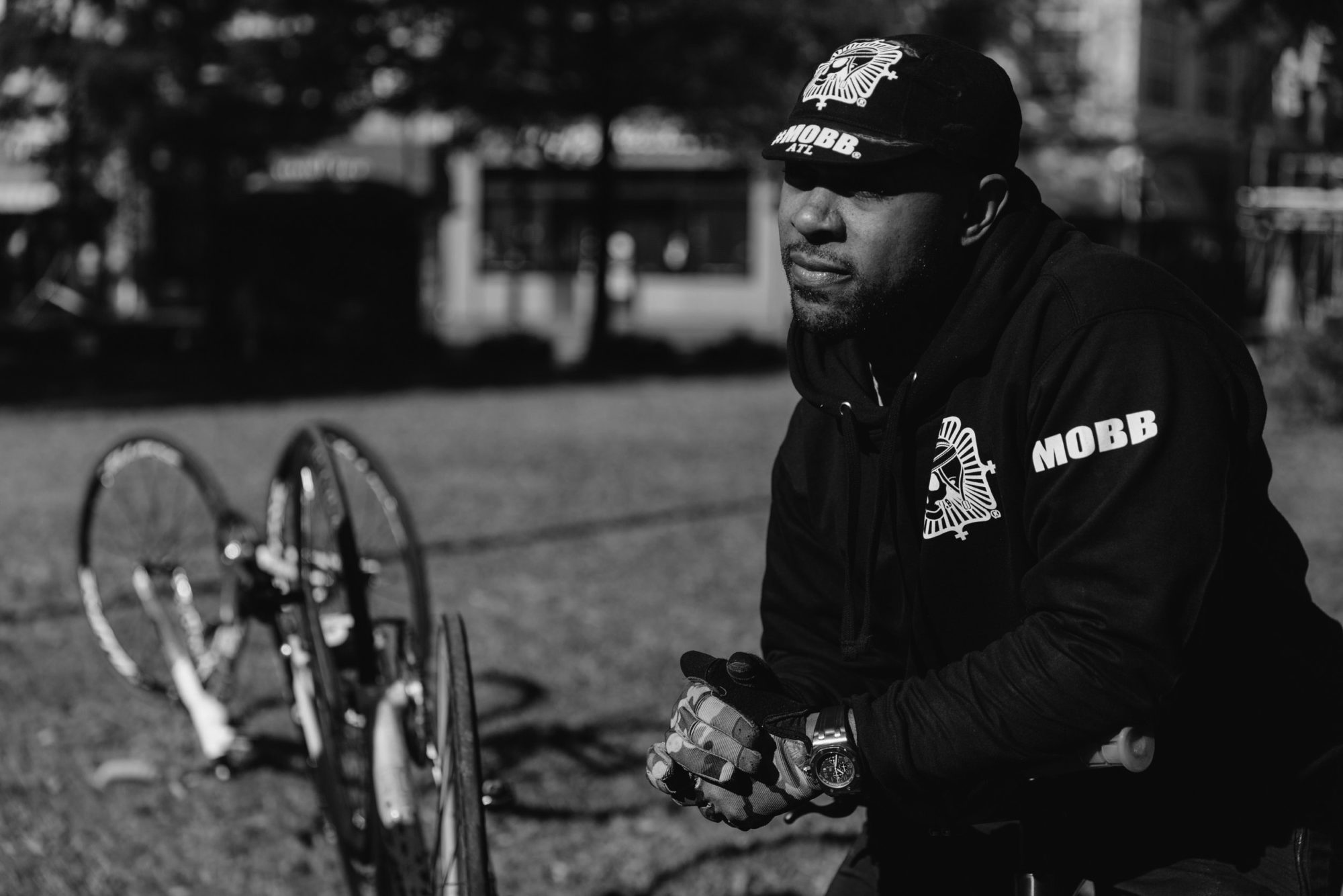 A cyclist stairs into the distance, with two bicycles in the background.