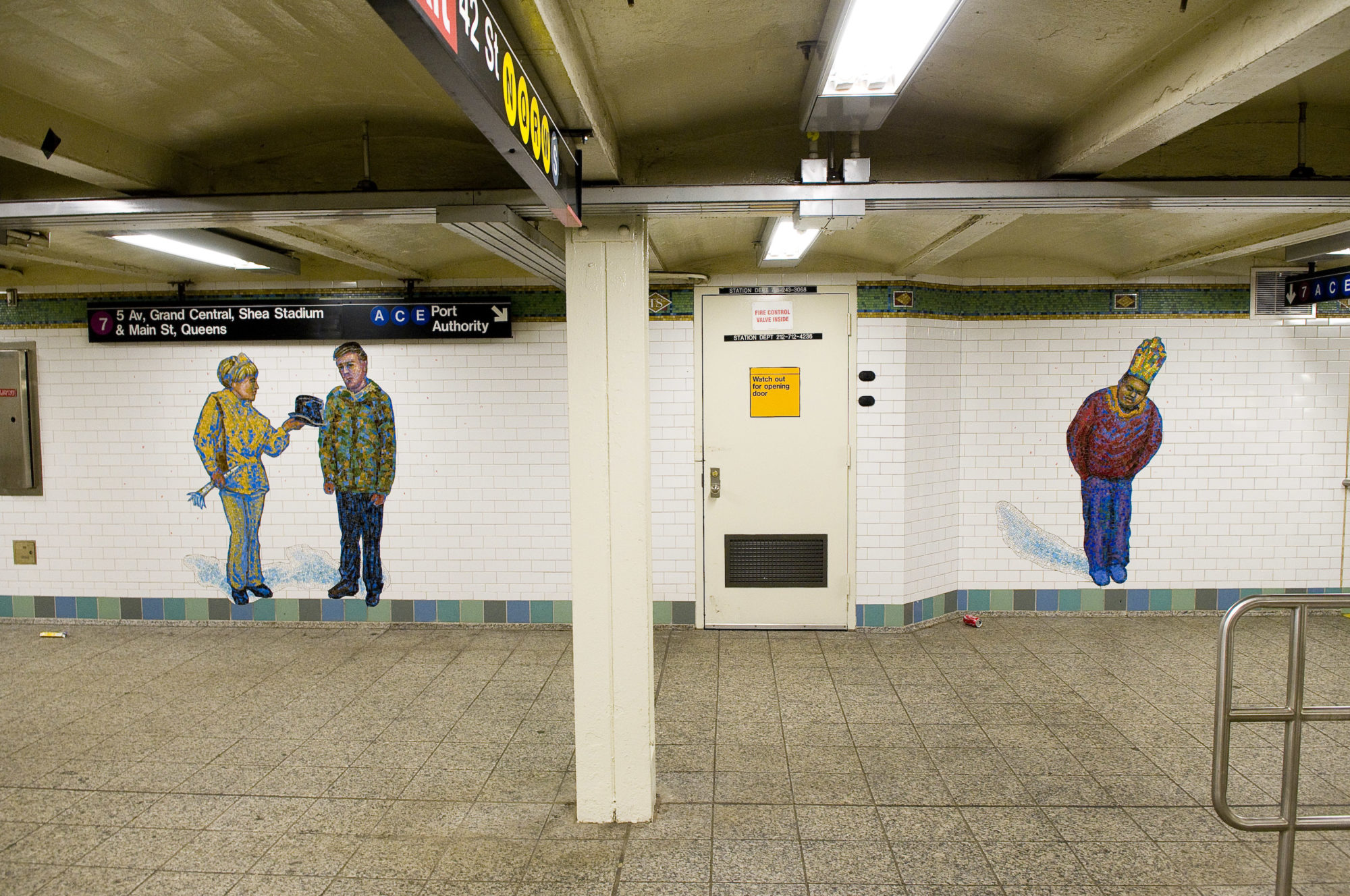 A picture of two mosaics at a subway station