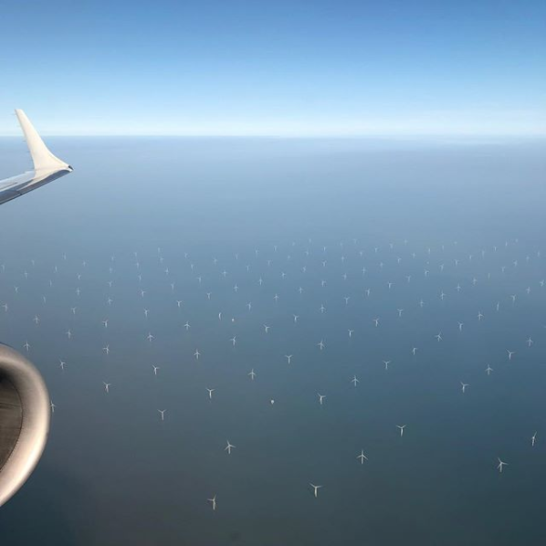 windmills in a large expanse of blue