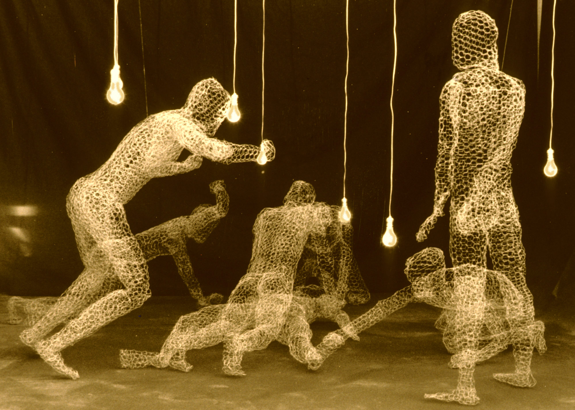 *Content Warning* five male figures, constructed out of metal wire, crowd around a male figure raping a female figure.