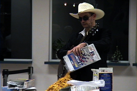 man with cream hat pouring cereal out of the box onto another box