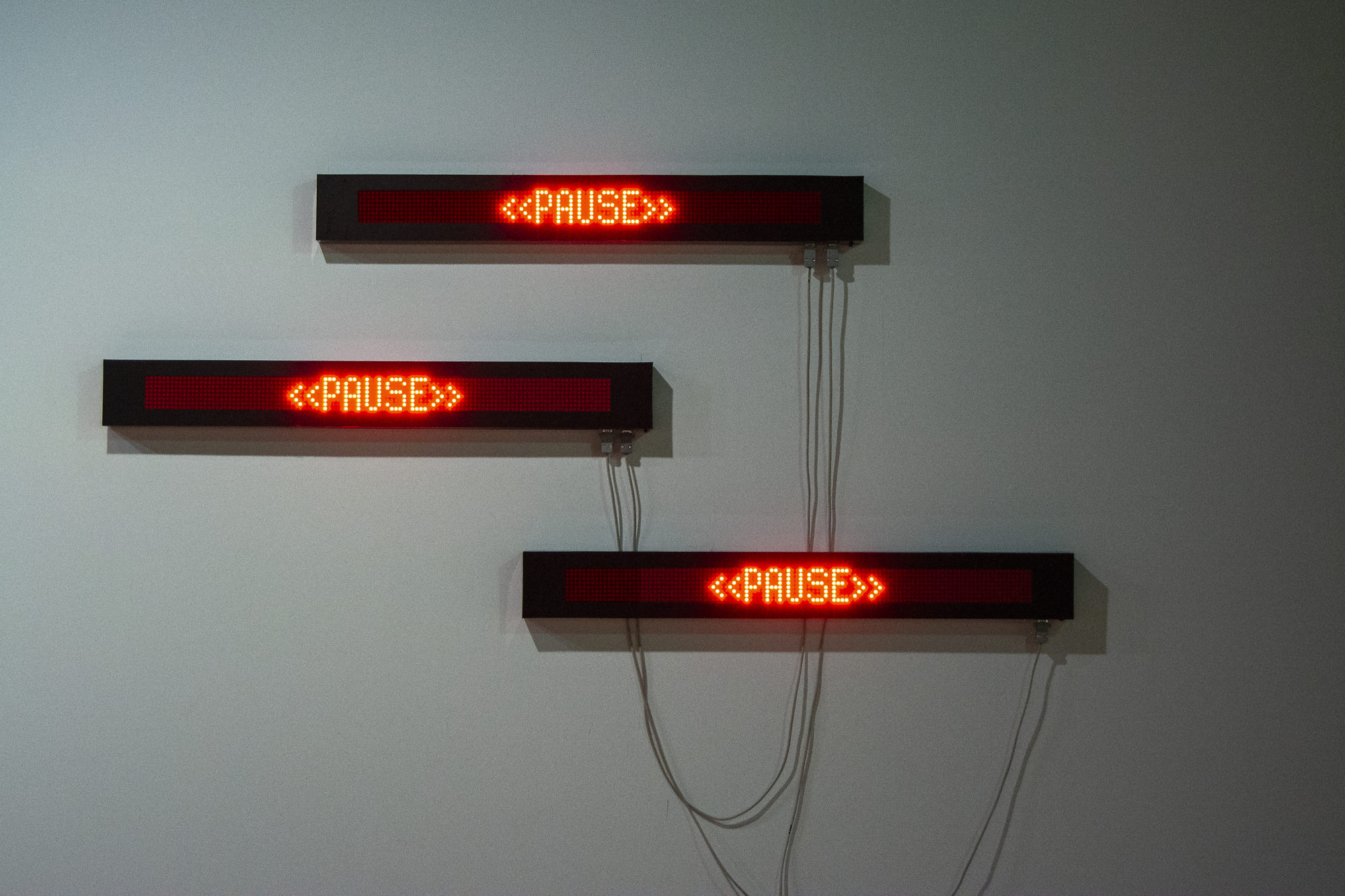 three illuminated neon dot-signs that read 