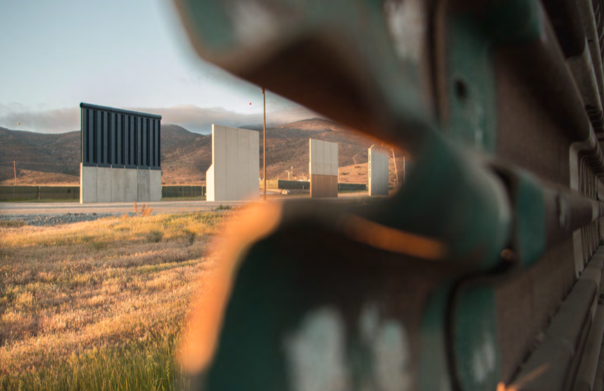 photo of out-of-focus wall taken from an angle, separate wall panels in background in mountain setting