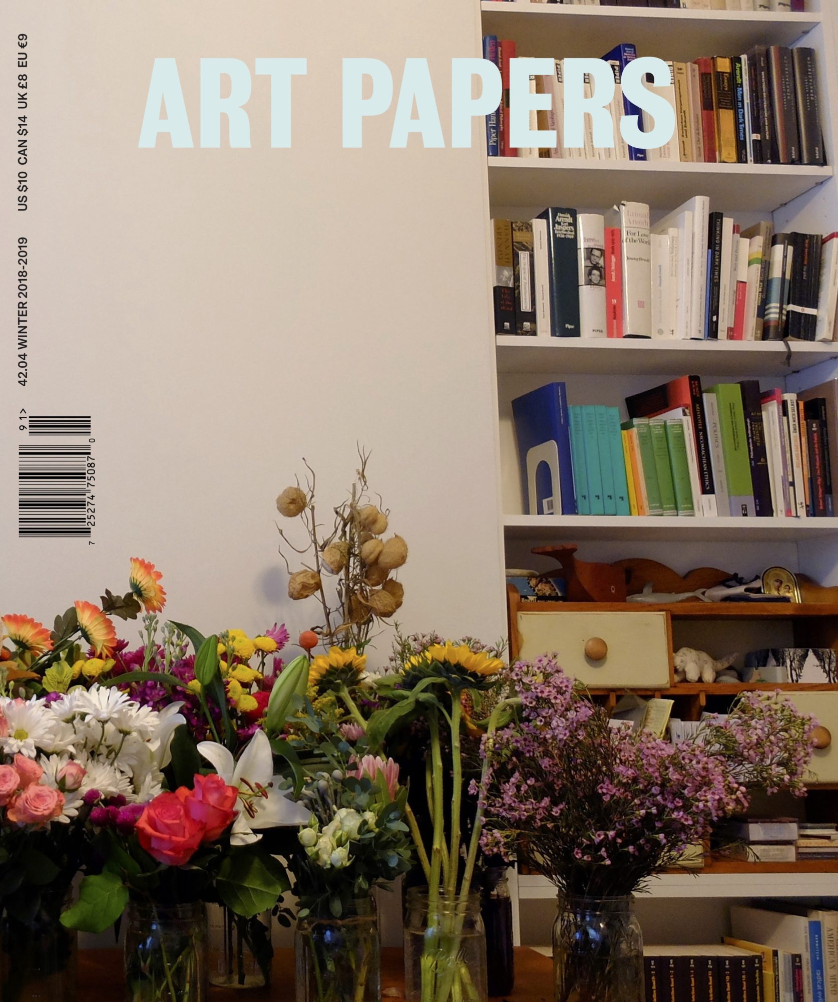 cover of art papers winter 2018 magazine with art papers name center-aligned, photo of bookshelf in the background and colorful flowers in vases in foreground
