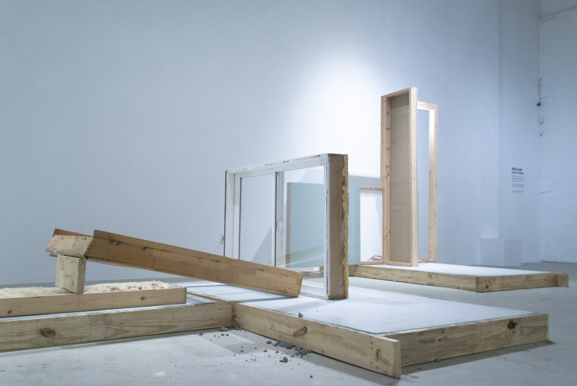 construction site with wood blocks and windows staged in museum space