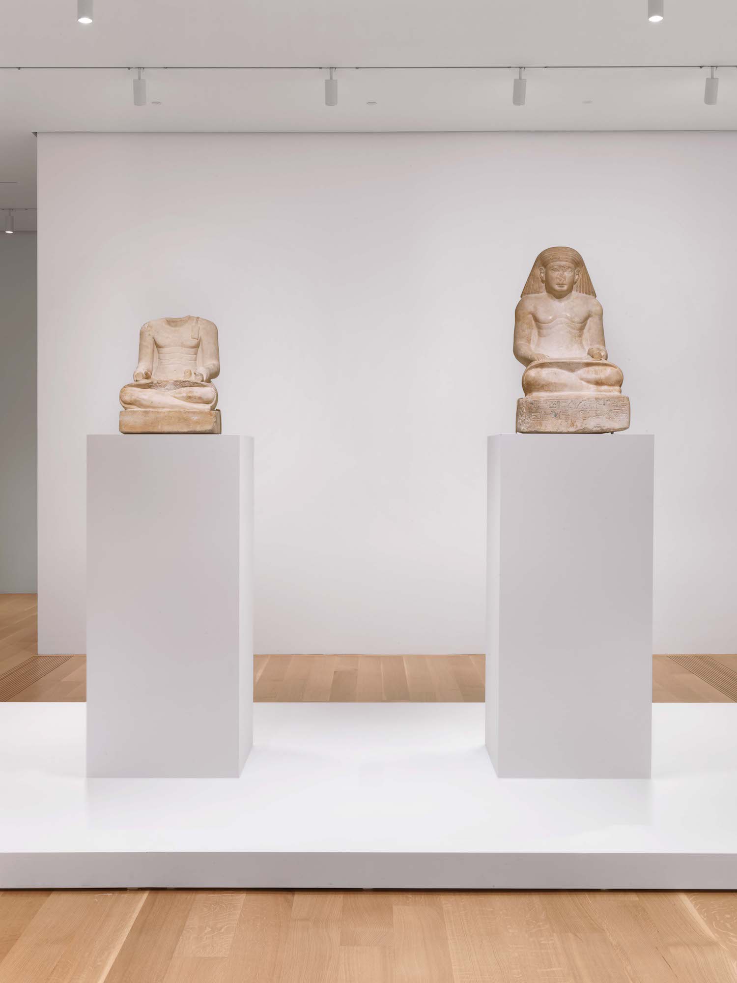 photo of two statues in an ancient Egyptian art exhibition.