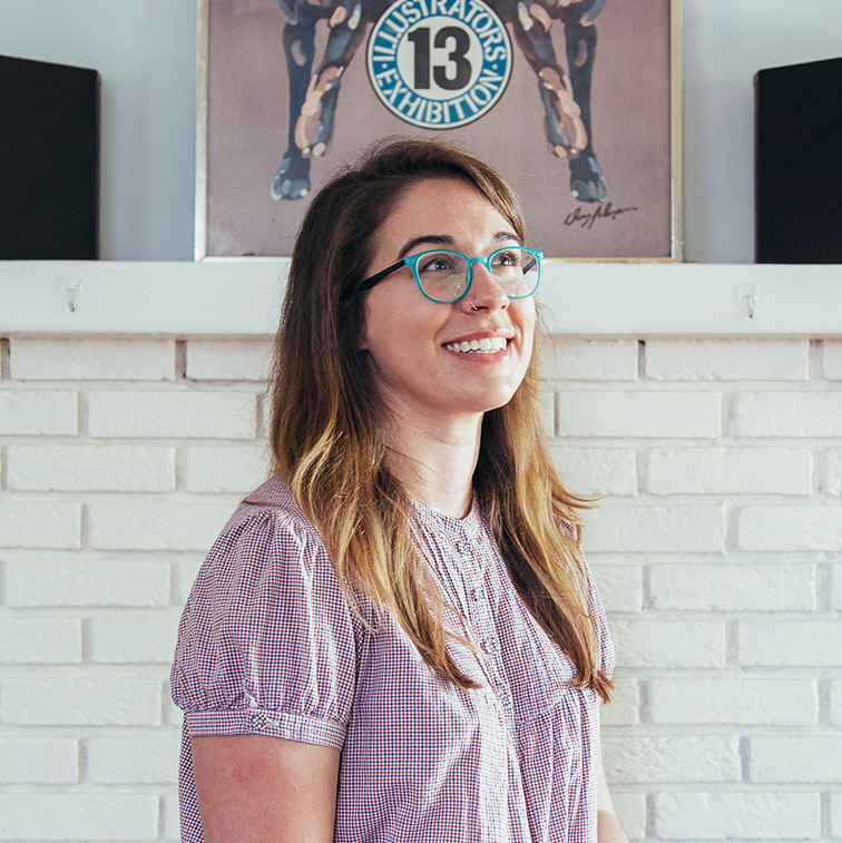 Sarah Lawrence wearing glasses and a purple shirt