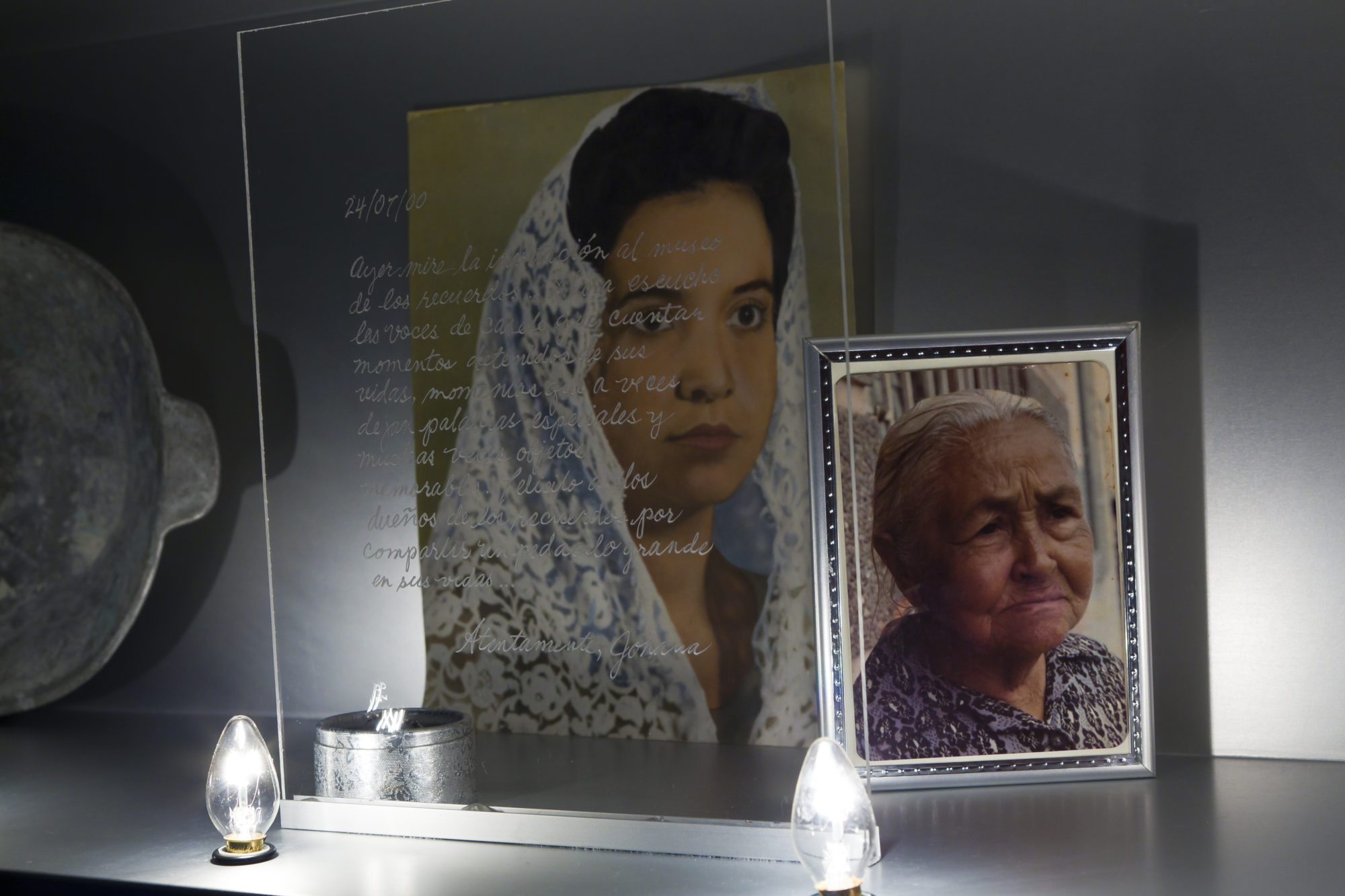 two portraits of woman and letter written on glass